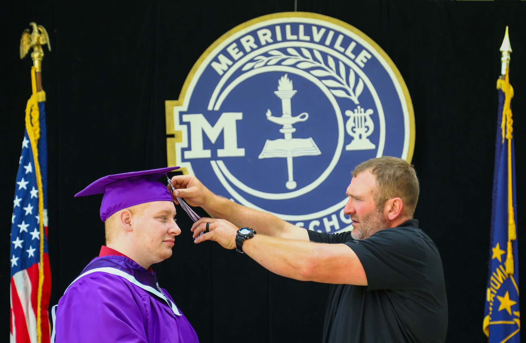 Merrillville High School seniors participate in a "drive-up" graduation